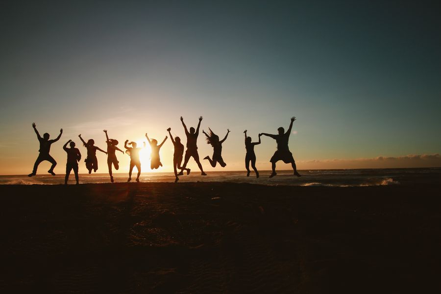 silhouette photography of group of people jumping during golden time — Street level: navigation, rideshares and reviews, all instant.