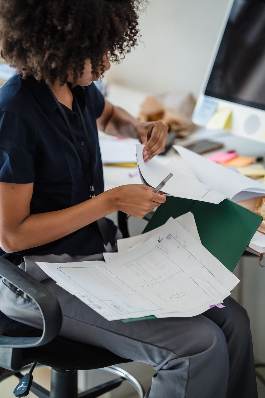 woman working with documents in office — Data Balance: tell it about the trip, get the answer in under a minute.