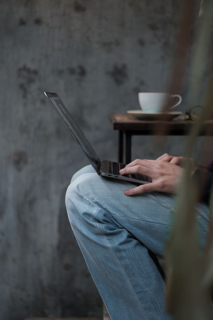 close up of man working on laptop — Downtown, connected: the eSIM finds the fastest local network on its own.