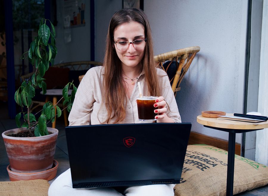 a woman sitting with a laptop — Free Wi-Fi Finder runs in your browser session — nothing sensitive stored against you.