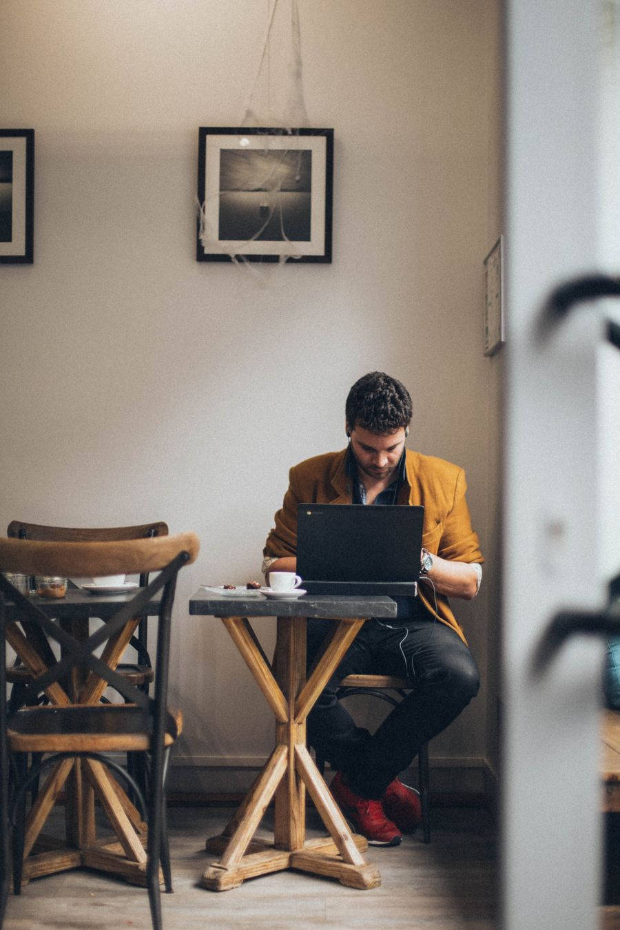 man using laptop computer — Platform to platform: tickets, timetables and taxis in one hand.