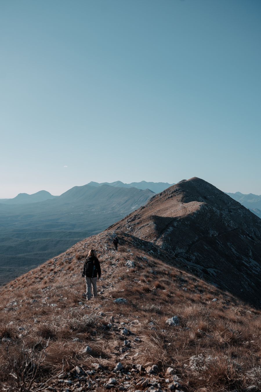 woman hiking on hill — Dual-SIM Setup Guide: built for the airport sprinter and the careful planner alike.