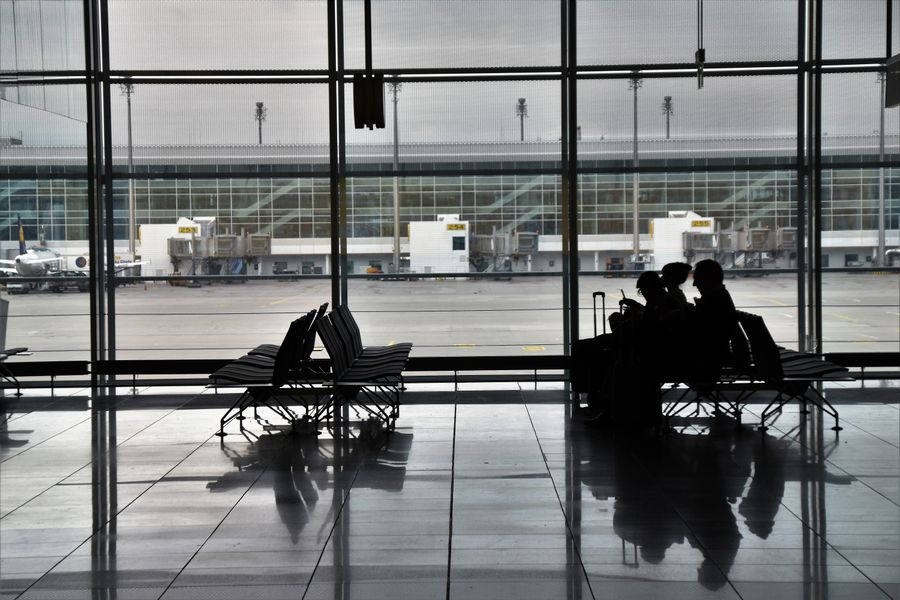 people sitting on chairs in airport