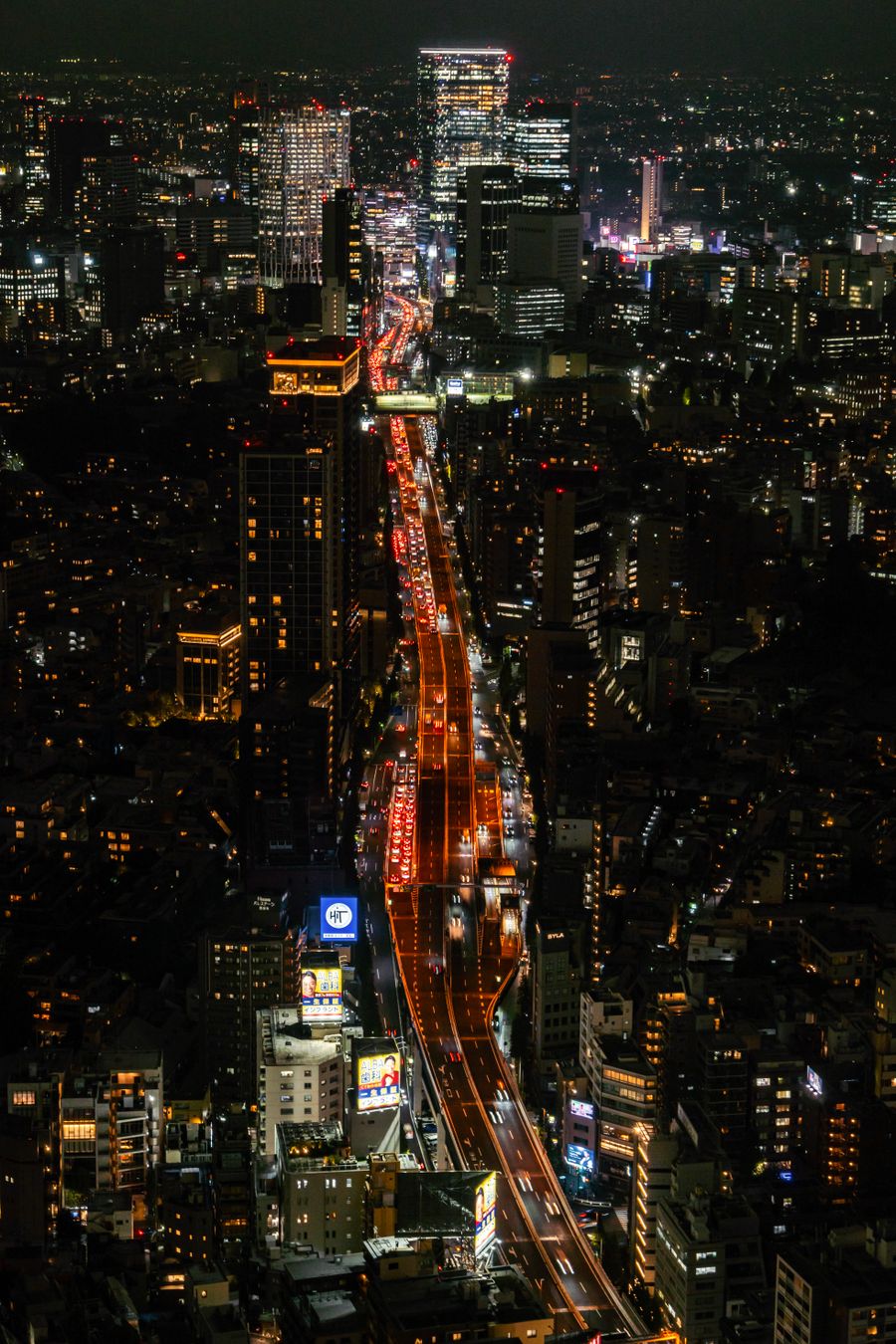 tokyo night cityscape with busy traffic — City lights after dark — the eSIM doesn't care what time it is.