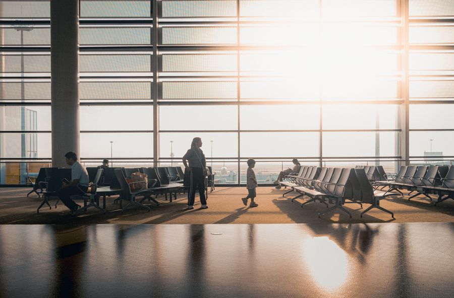 modern airport terminal with travelers at sunrise — Latency to Destination: answers first, never a signup wall.
