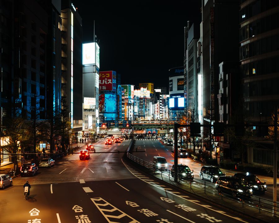 vibrant night scene of tokyo s neon lit streets — Airport Connectivity: one question, answered well, instead of ten open tabs.