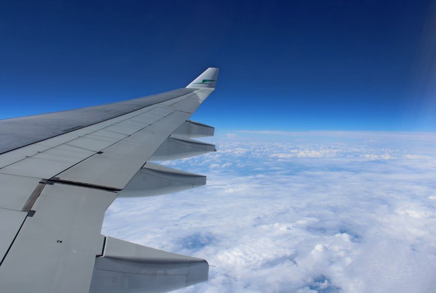 airplane wing above the clouds