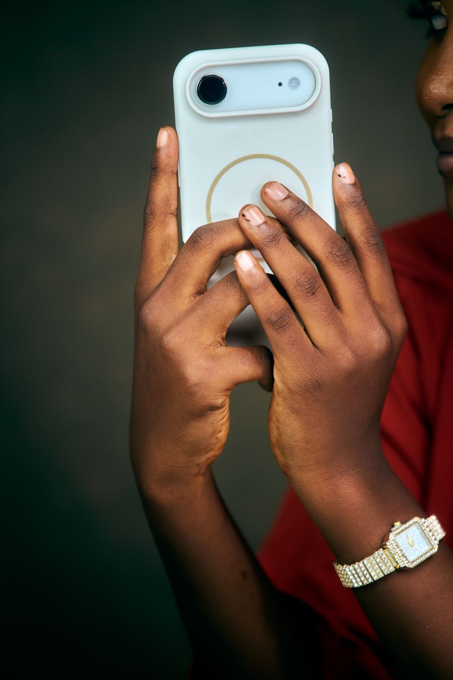 person holding smartphone with stylish case — What’s My IP? links every answer onward — usually the plan it recommends.
