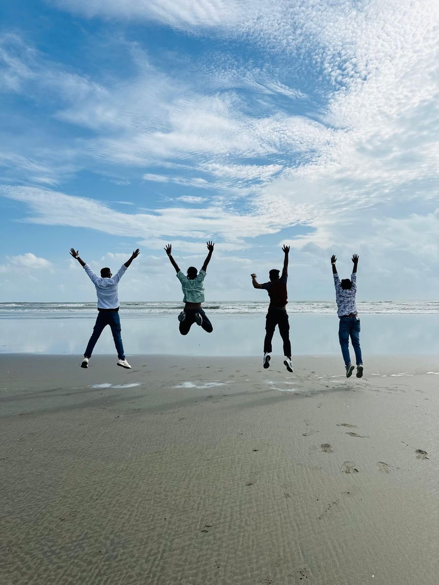 friends jumping together on a beach — Night markets and late trains — connected the whole way through.
