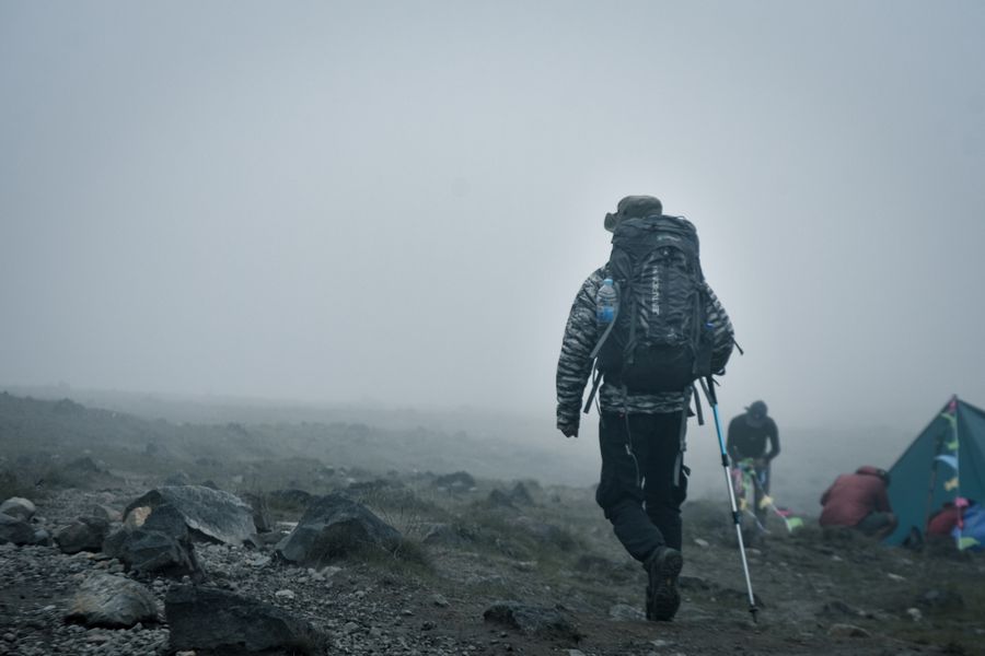 adventurer hiking in foggy mountain landscape