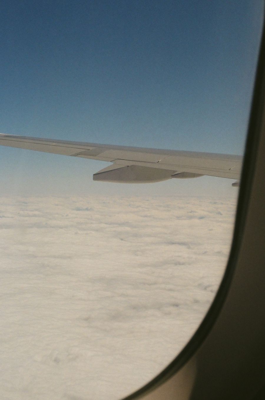 aerial view from plane window showing clouds — Airport Connectivity accepts your trip details and hands back a clear recommendation.