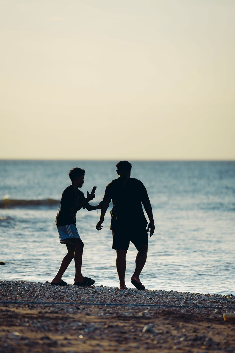 silhouette of two friends enjoying a beach sunset — The capability matrix lists everything Airport Connectivity does — no asterisks.
