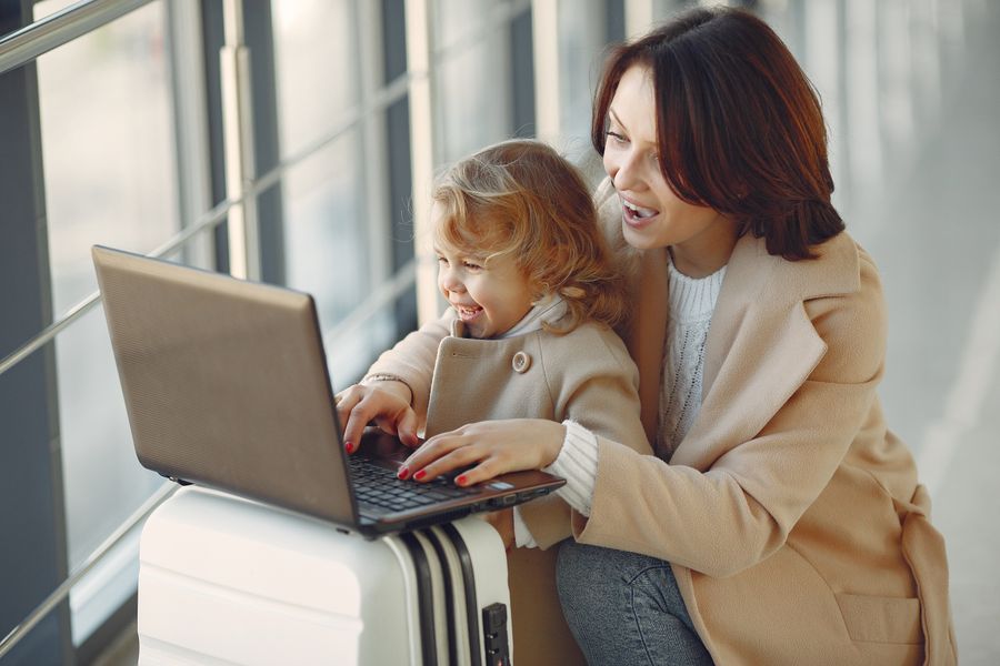 delighted mother with daughter typing on laptop in airport — Rerun-friendly by design — the tool expects you to compare options.