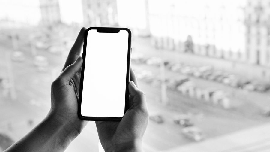 grayscale photo of person holding smartphone — Roaming Cost Calculator: one question, answered well, instead of ten open tabs.