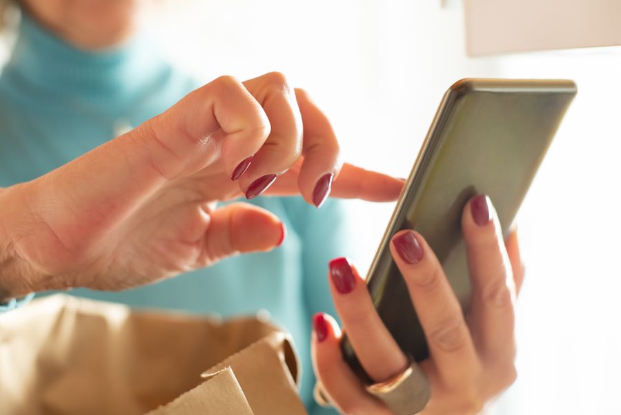 close up photo of person using smartphone — Island time, online time: ferries, beaches and full signal.