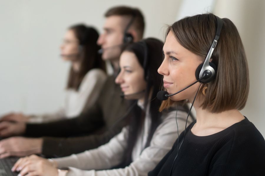 operators with headphones with microphone working on netbook in room — Museum afternoons with audio guides streaming, not buffering.
