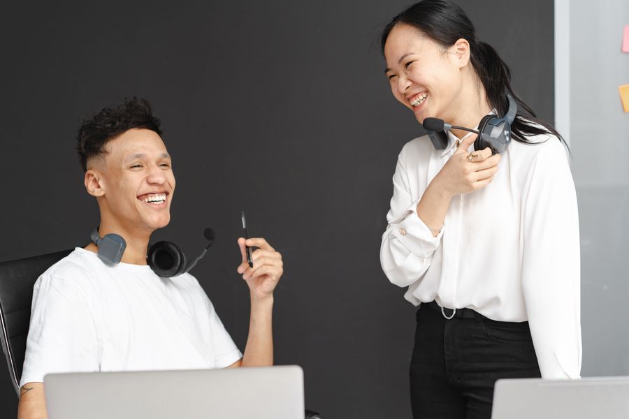 laughing man and woman working in a call center — Country Connectivity Fact Sheet: built for the airport sprinter and the careful planner alike.