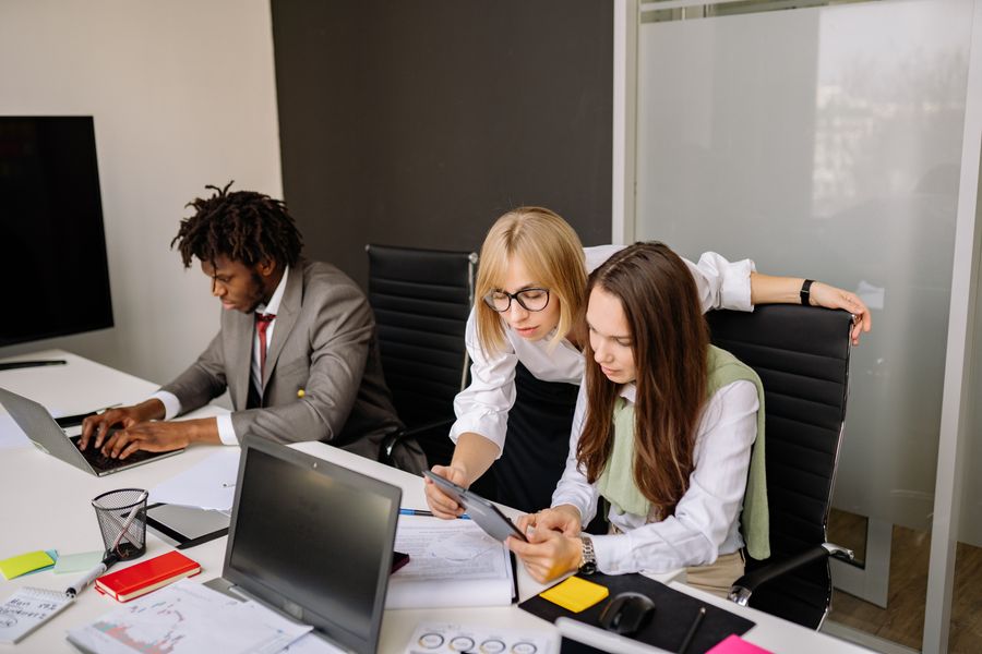 employees busy working inside an office — Share the result — everyone plans from the same numbers.