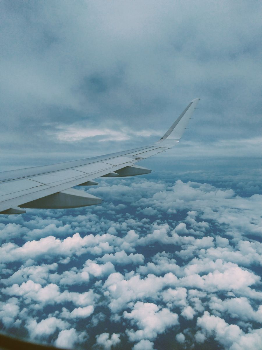 airplane wing and thick clouds — Café office: hotspot running, video call stable, no hotel Wi-Fi roulette.