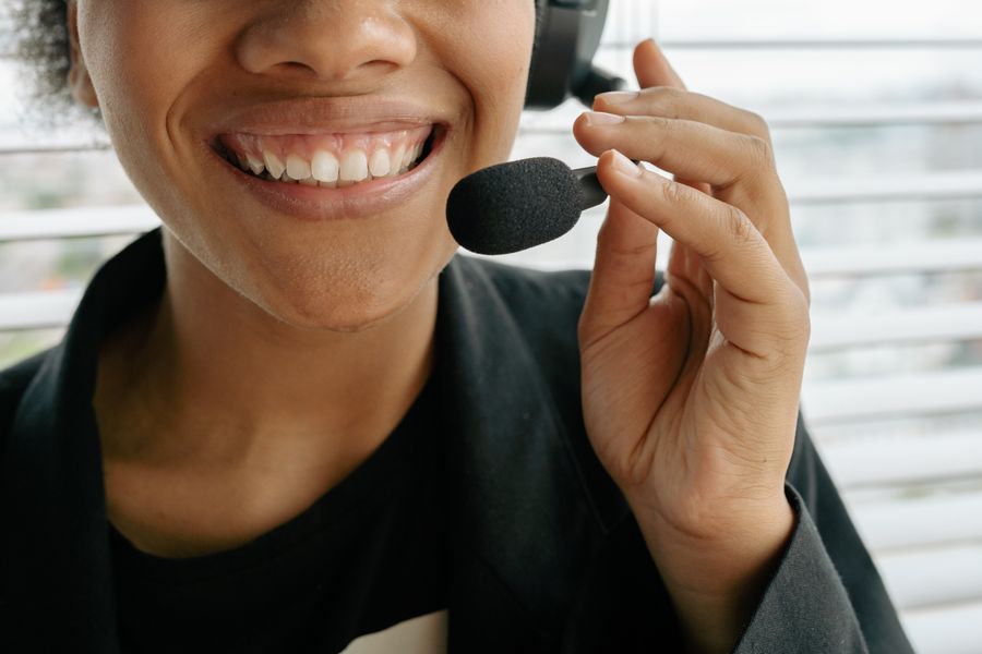 close up photo of a smiling woman holding microphone — Every run of My Active eSIMs is free — no credits, no paywall, no expiring trial.