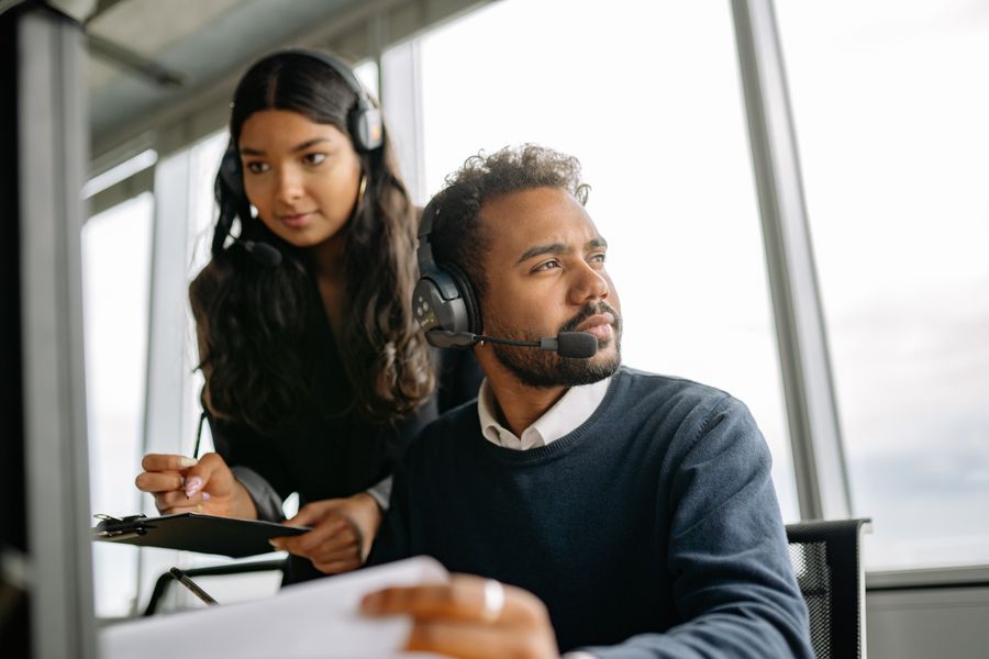 man and woman wearing headphones while working in the office — Changelog: プレスリリースより先に変更履歴を — こちらの方が正直です。