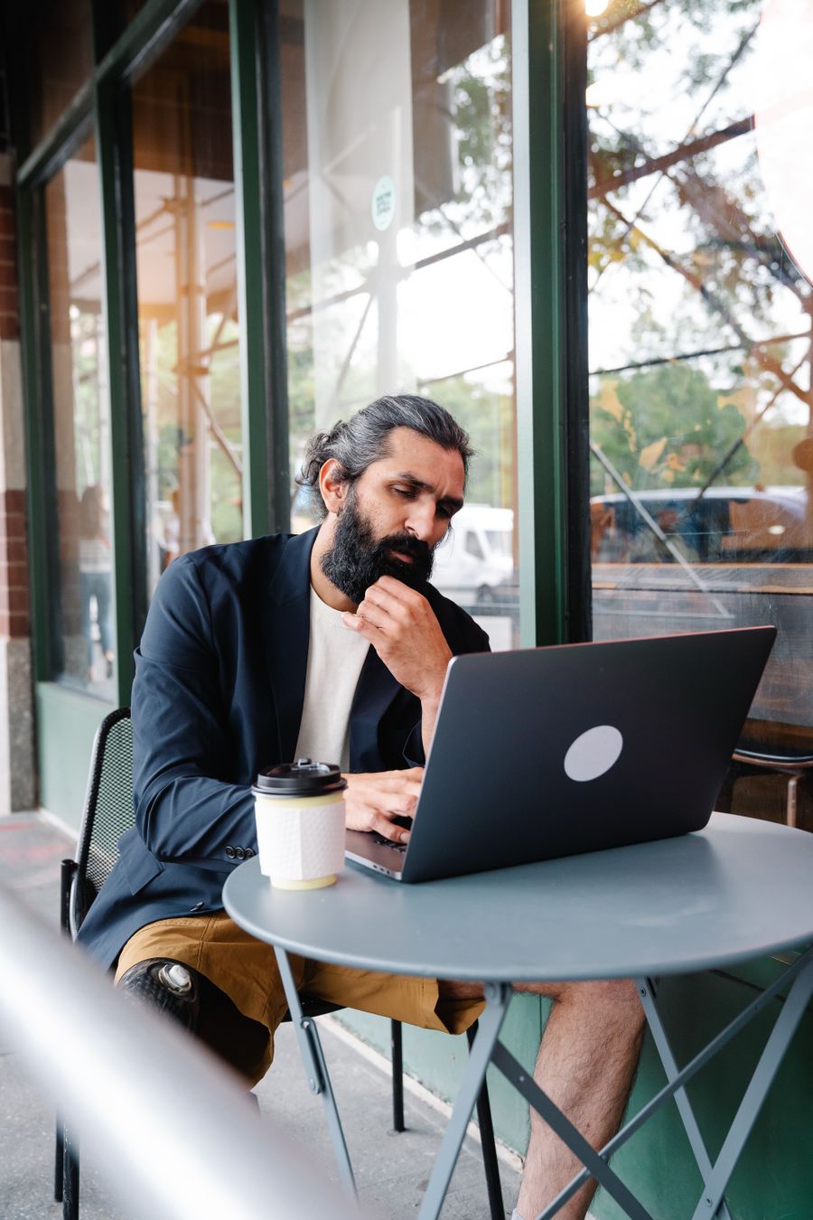pensive man looking at laptop — Rain or shine, the connection holds — weather doesn't throttle data.
